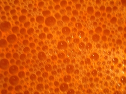 A photograph showing a close up view of the soapy bubbles, revealing a distinctly hexagonal shape