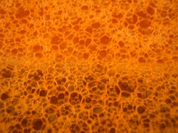 A photograph showing an array of hexagonal bubbles beneath the surface layer