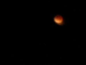 The Moon is a blood red colour as it is eclipsed by the Earth's shadow