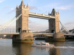 Photograph of tower bridge with a boat passing beneath