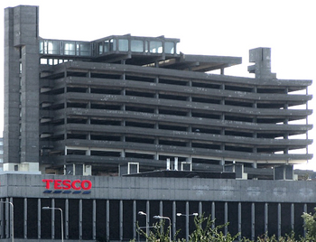 A photograph of the current Tesco, with the car park behind