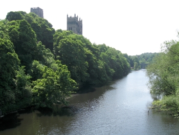 Photograph looking along the river in Durham, with the cathedral towering above