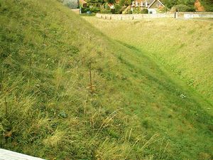 Acre Castle: Photograph of ditch around the exterior of the bailey rampart